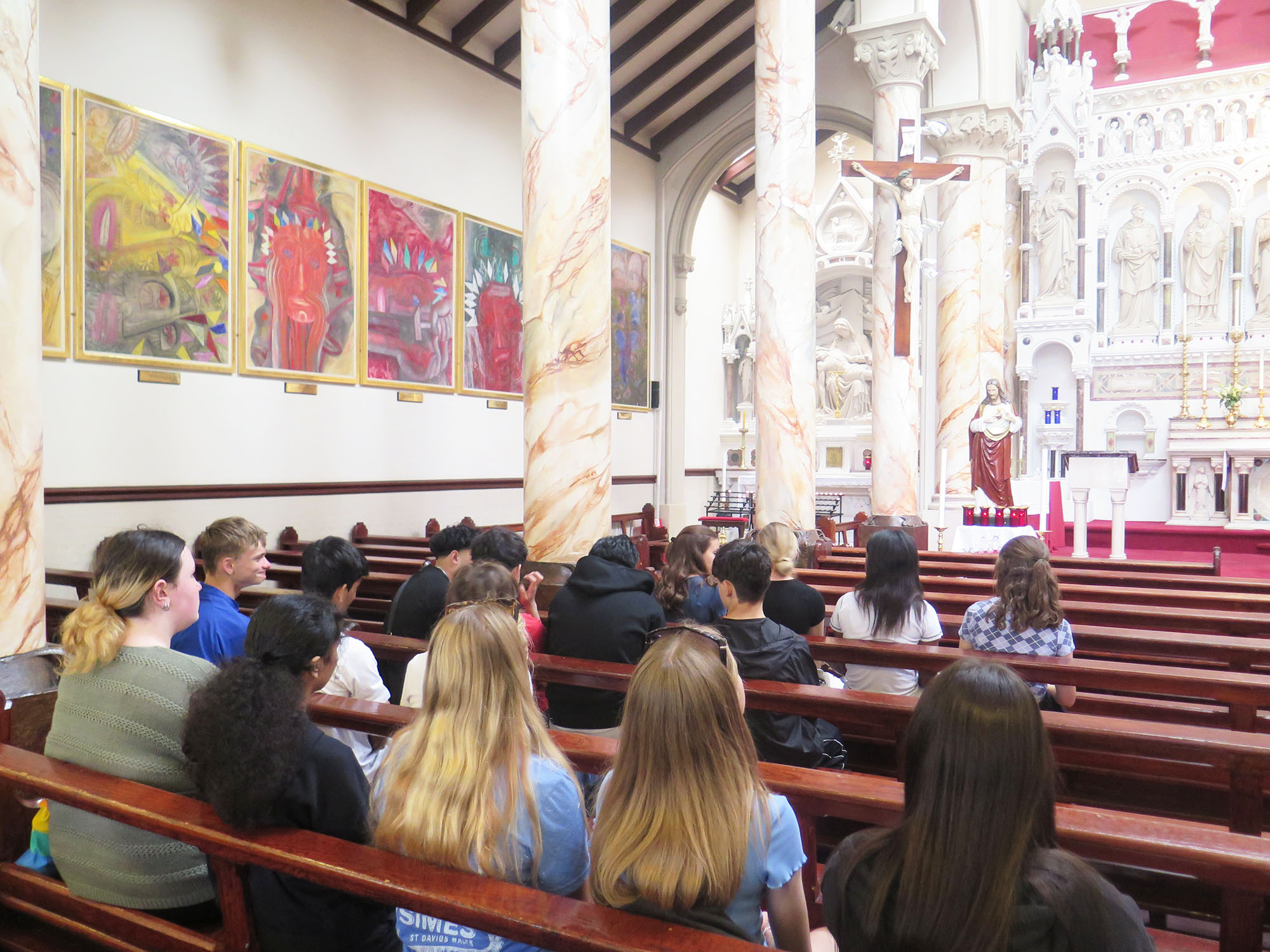 Pupils sit in pews in a church during a Religious Studies trip to Manchester