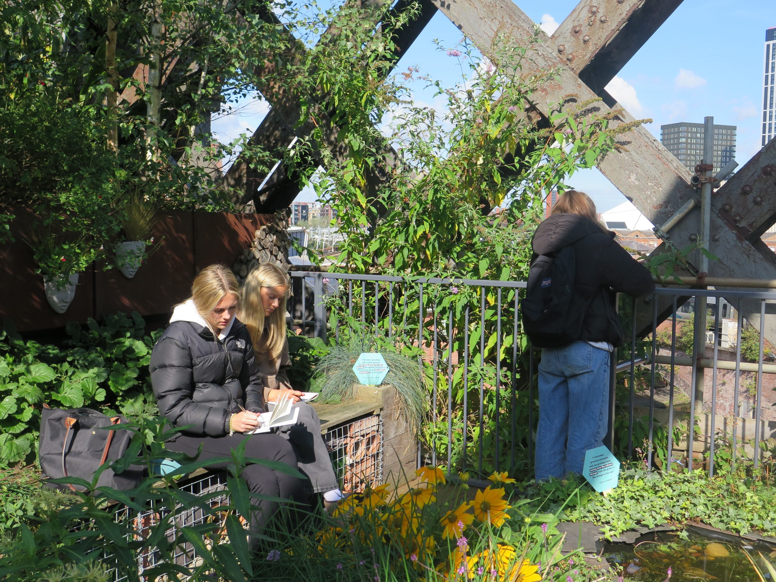 Students drawing on Castlefield Viaduct during their art trip to Manchester