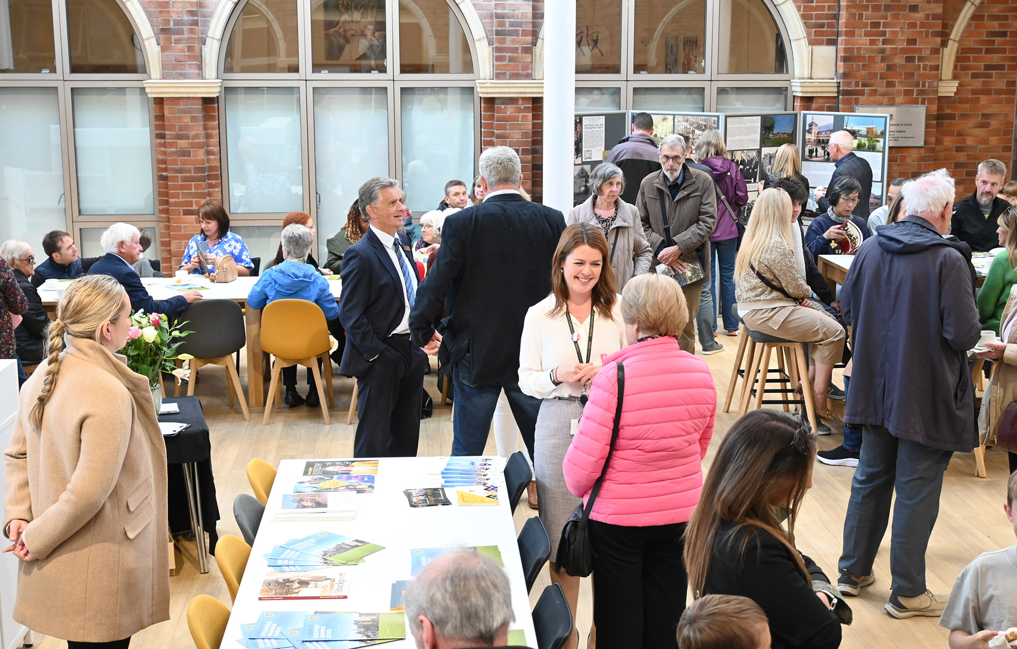 Attendees at the Community and Heritage Open Event mingle in the Sixth Form Common Room