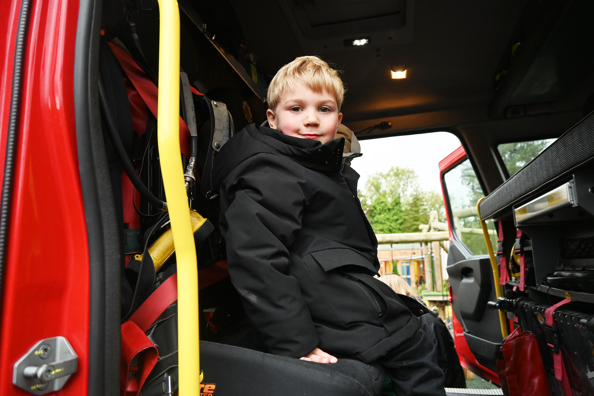 A Reception pupil inside a fire engine during a visit from the Fire Service