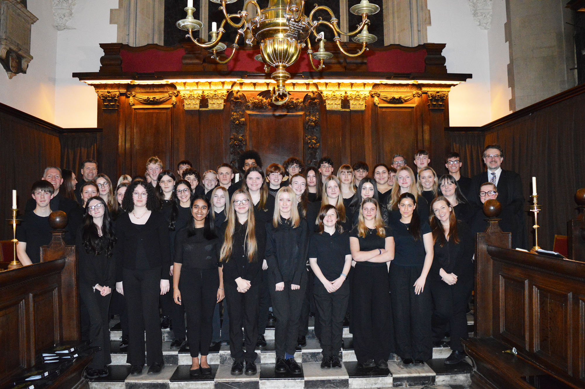 Chamber Choir members pose for a photo following the Evensong Service at the chapel at University College, Oxford