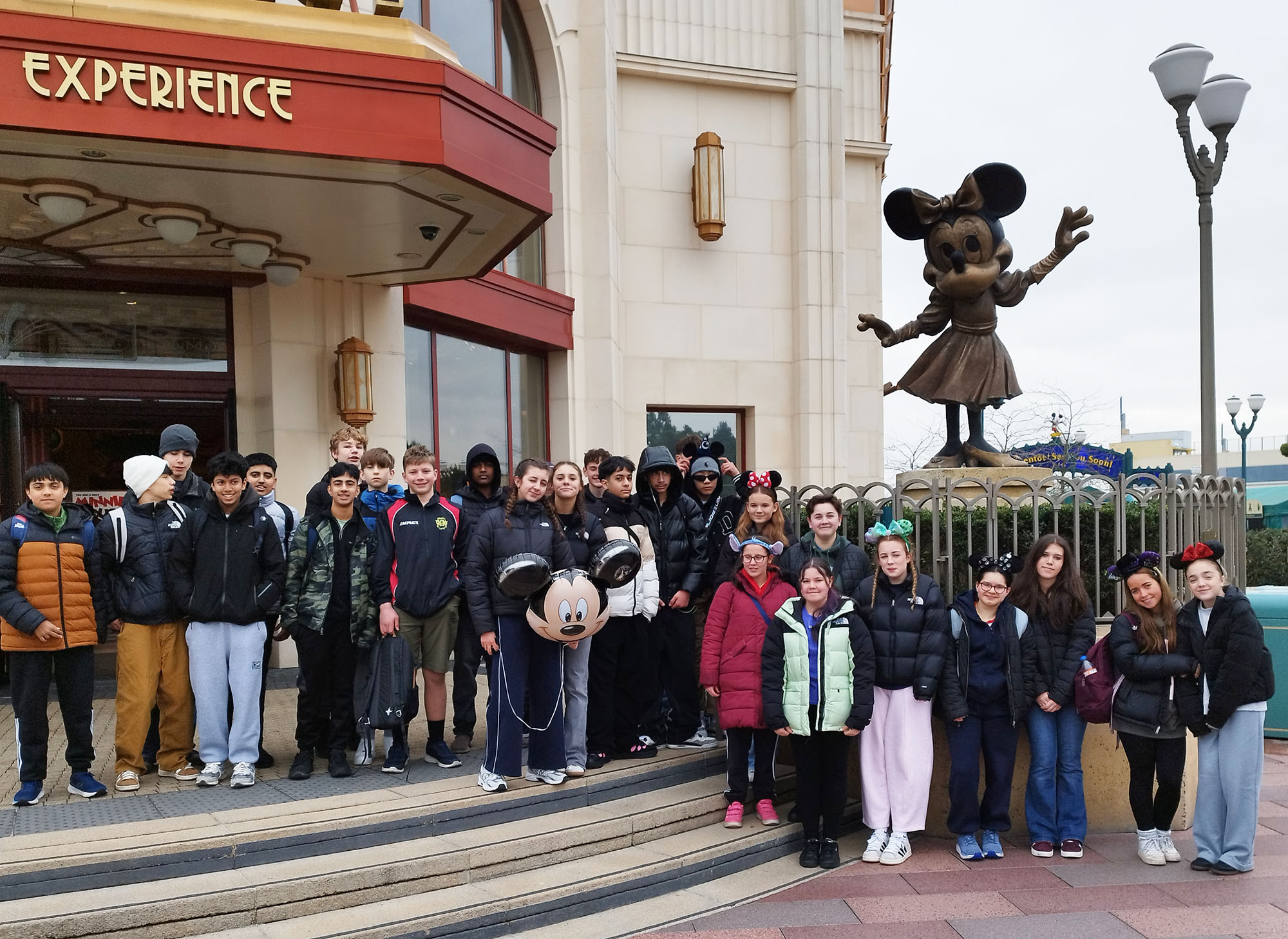 Fourth Year pupils pose for a photo in front of a statue during a Maths trip to Disneyland Paris