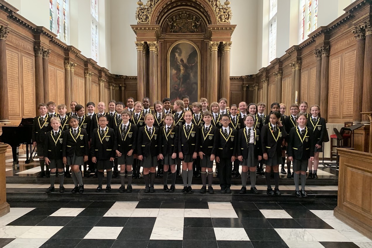 The Year 5 and 6 Choir pose for a photo in a church in Cambridge during their 2025 tour