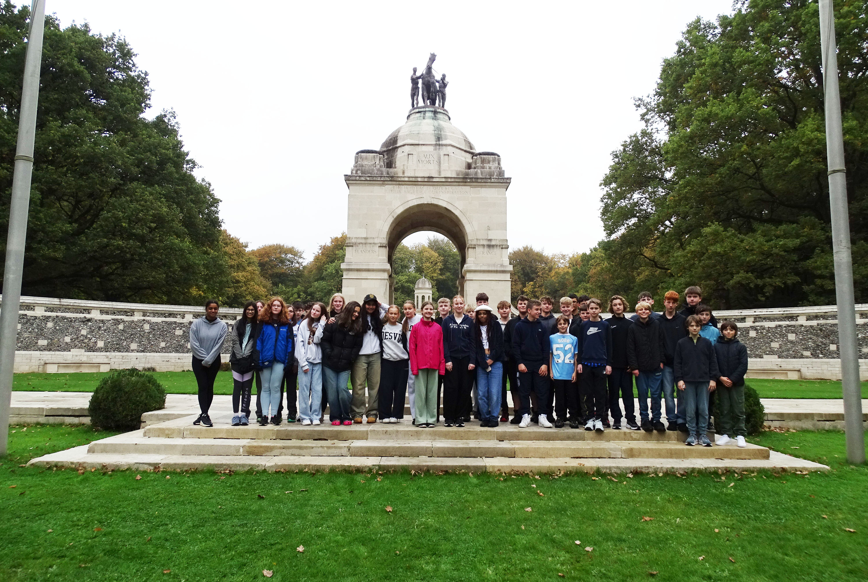 Pupils pose for a photo in front of a landmark during the 2025 Battlefields trip