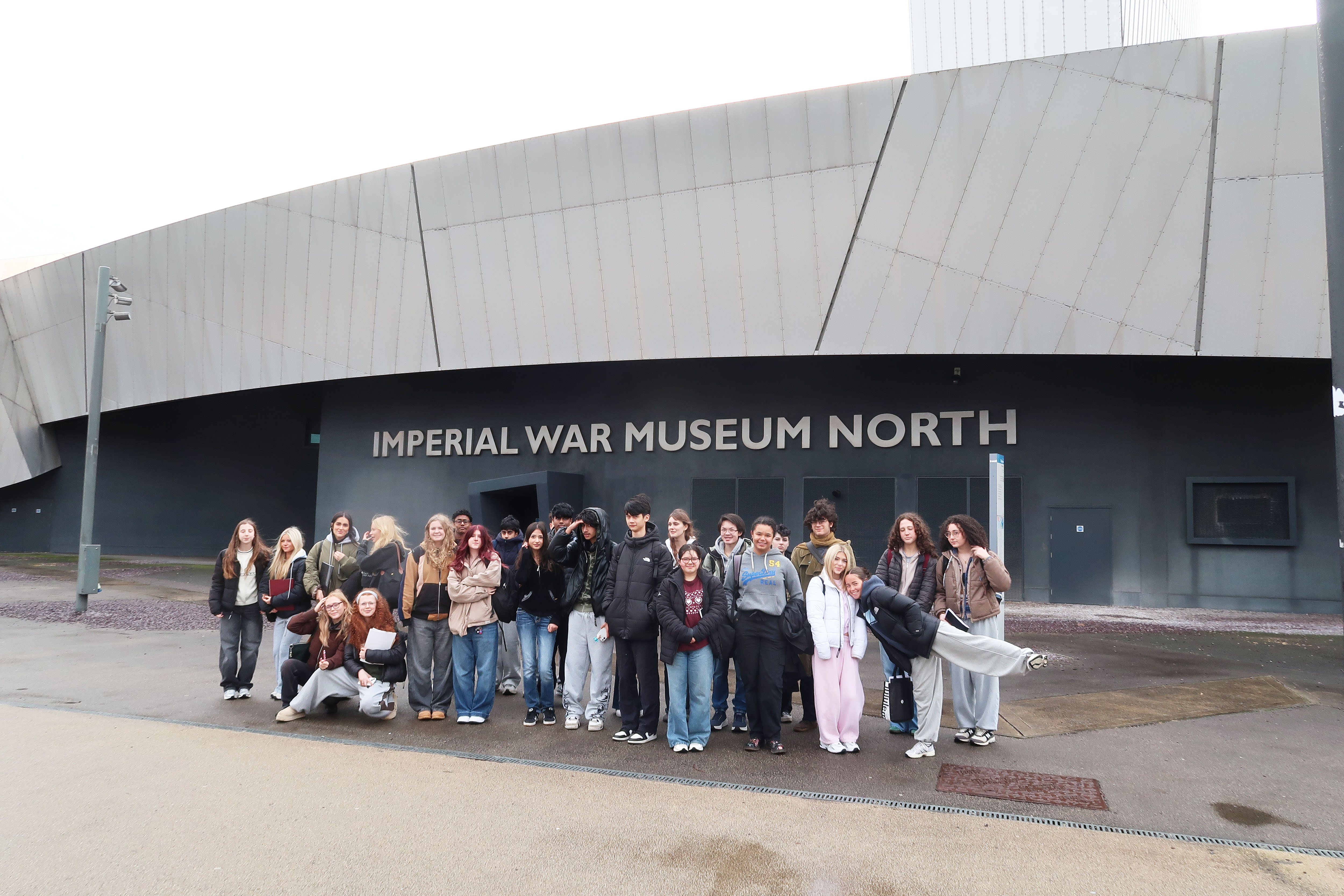 Fifth Years on the Art trip to Manchester and Salford pose for a photo outside the Imperial War Museum North
