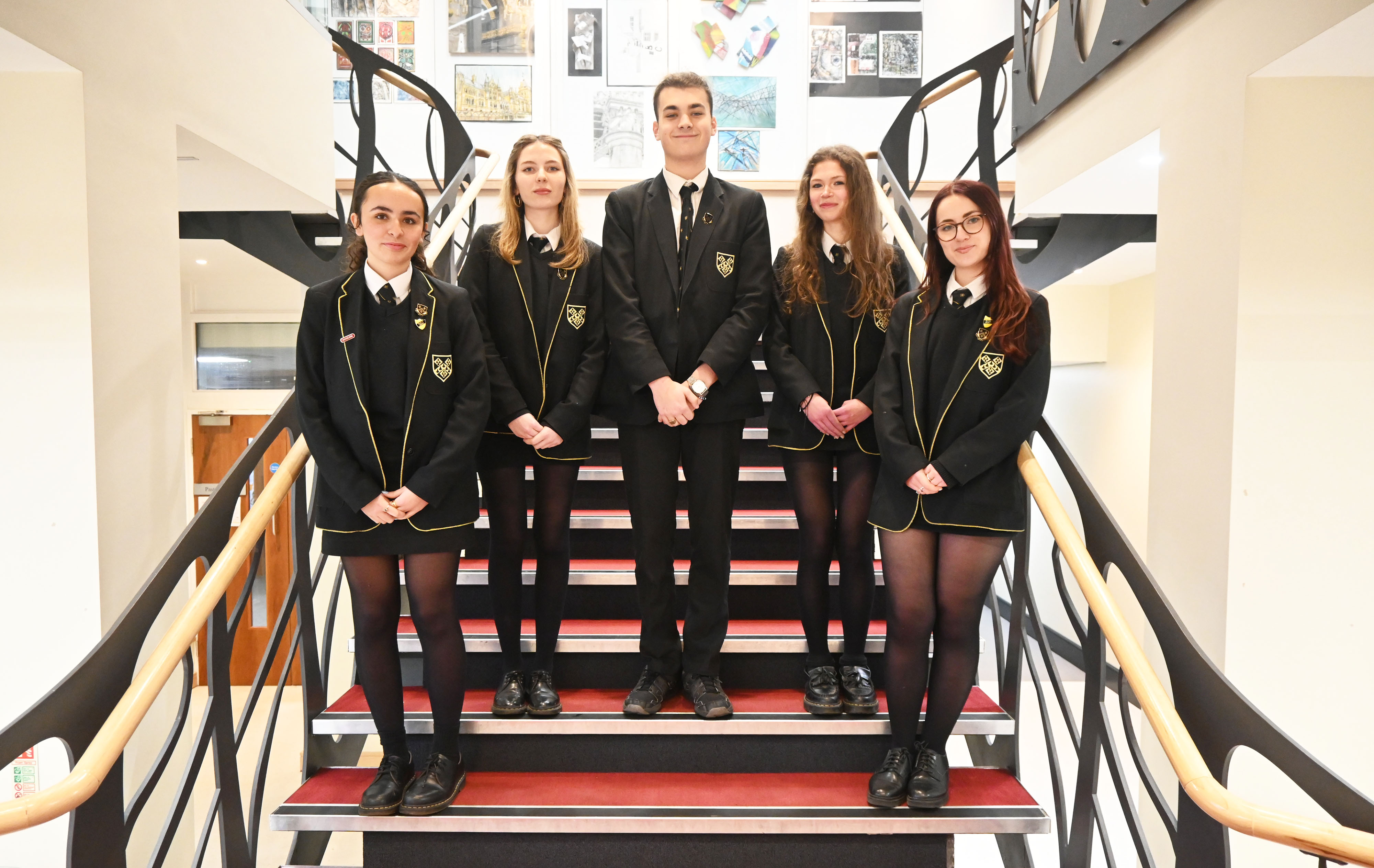 Cara, Annabel, Christian, Lucy and Tabby pose for a photo on the Main Hall stairs