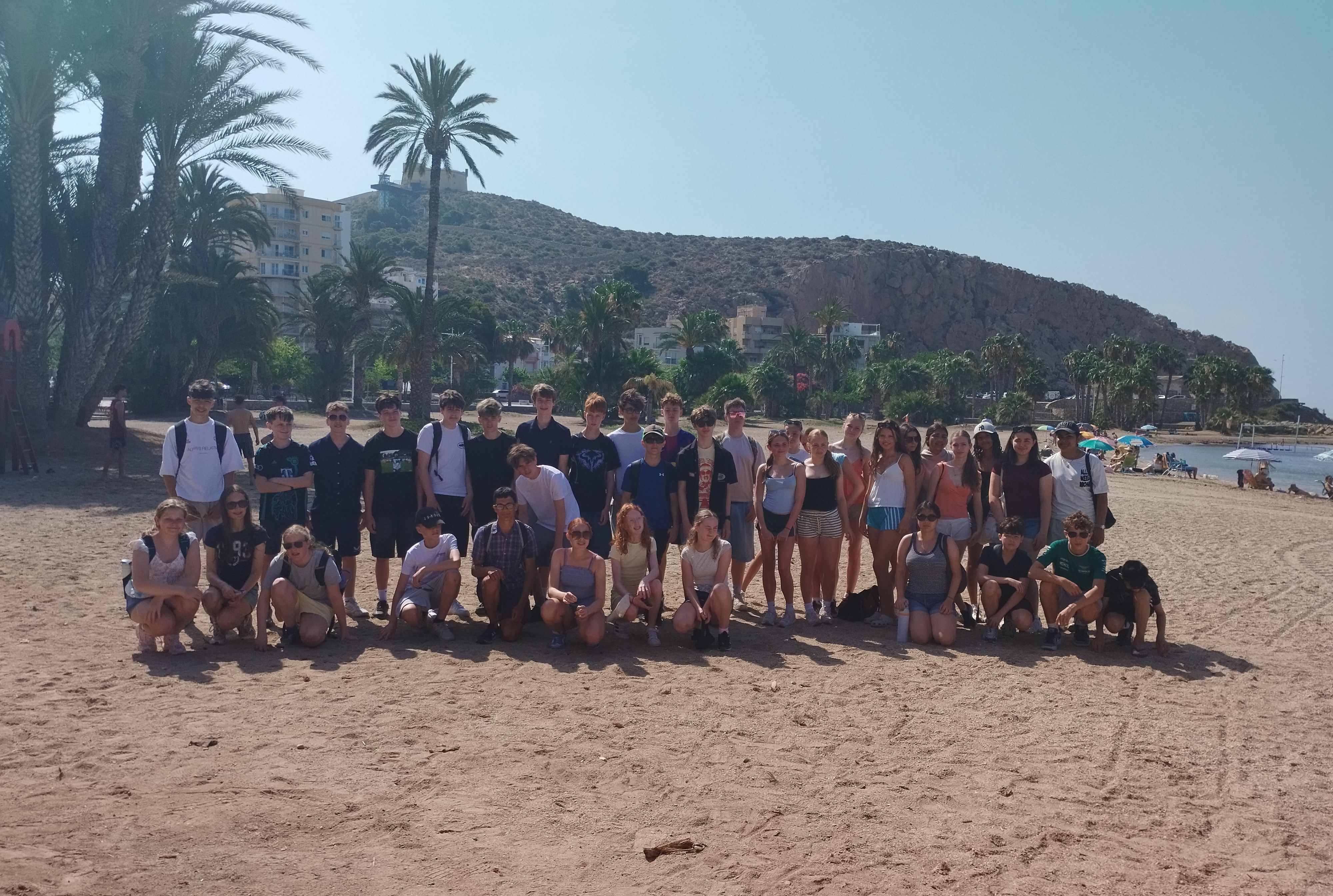 Pupils on the MFL trip to Spain pose for a photo on the beach