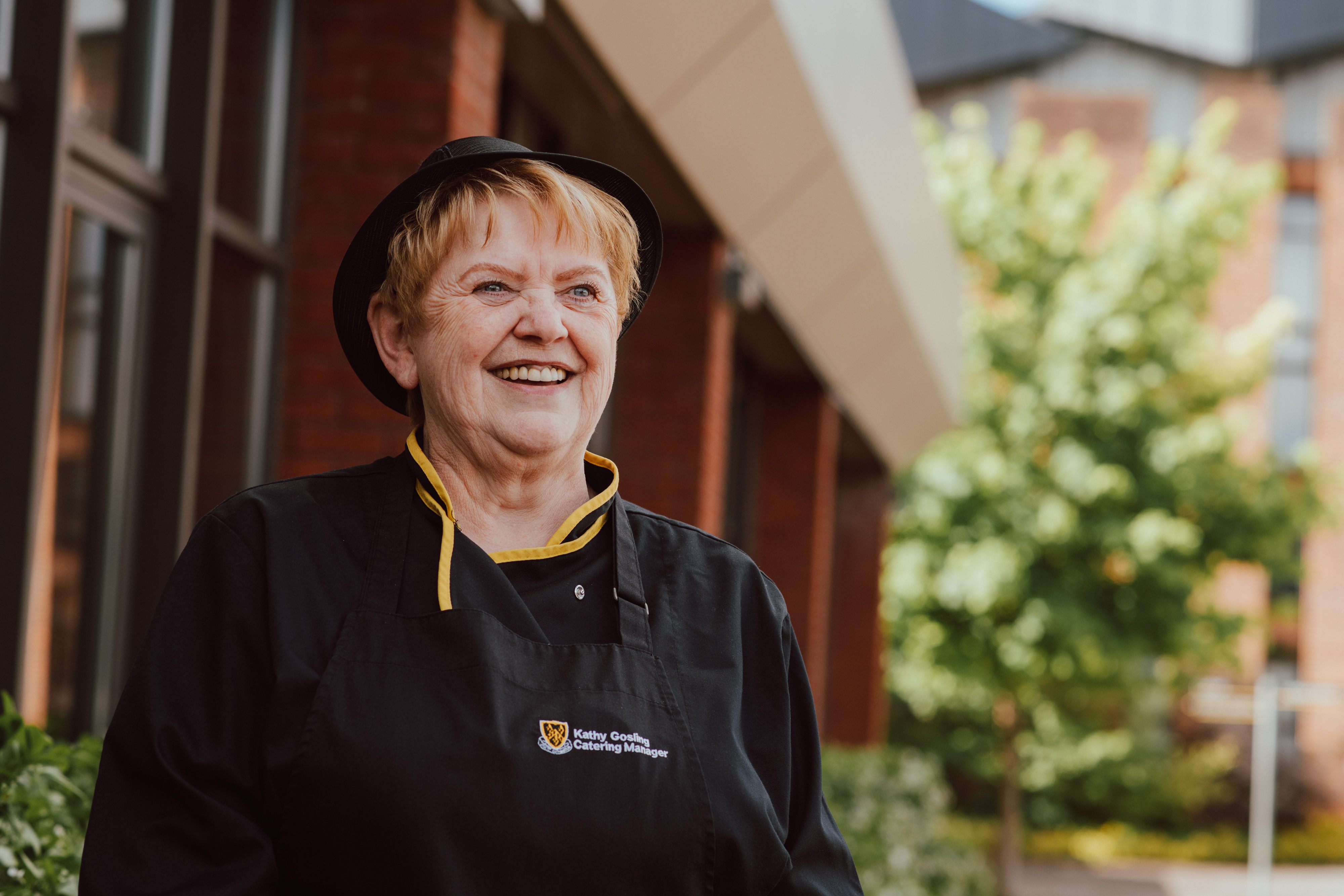 Catering Manager Mrs Kathy Gosling posing for a photo outside the Dining Hall